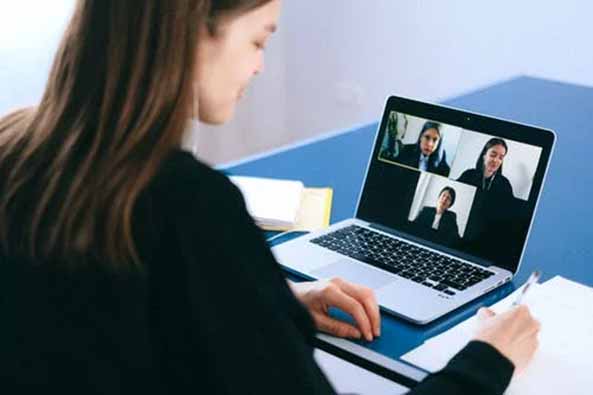 A woman having a video conference on a laptop