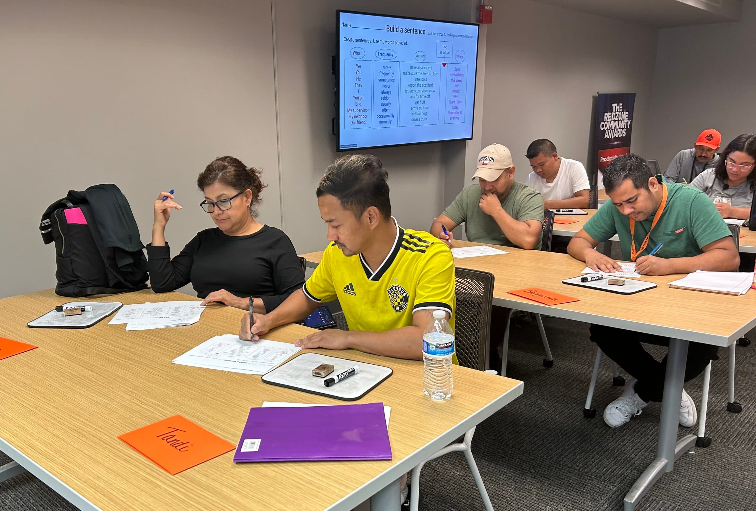 Employees in an onsite workplace language class built around real job tasks
