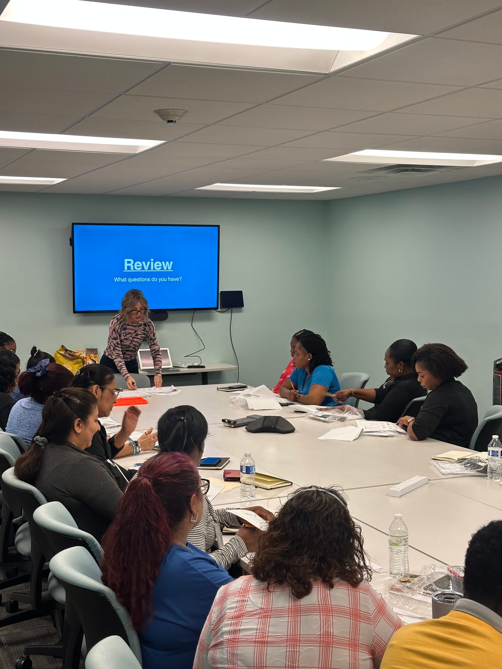 Employees receiving guidance during a workplace language assessment